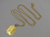 an image of a gold necklace with a picture of a woman on it