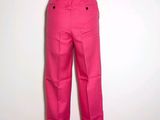 pink pants on a mannequin stand against a white wall