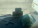 a hard hat sitting on the dashboard of a car