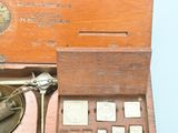 a wooden box with a scale and a pair of scissors in it