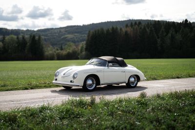 a white car that is driving down the road