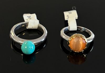 paire de bagues ornées de pierres sur fond noir, avec étiquette de prix