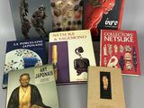 several books are sitting on a table next to each other