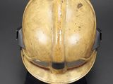 a close up of a fireman ' s helmet on a black surface