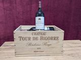 a wooden box with a bottle of wine inside of it