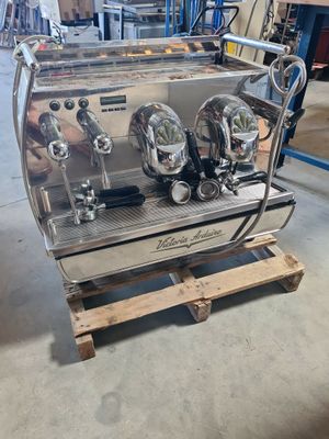 an image of a coffee machine sitting on top of a wooden pallet