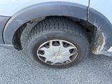 a dirty tire on the side of a car