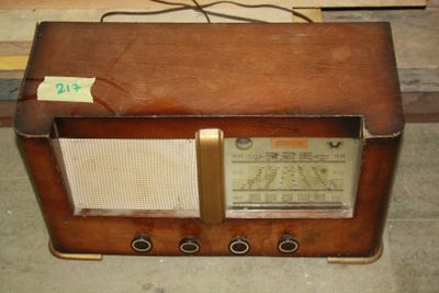an old radio sitting on the floor in a room