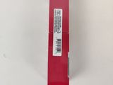 a red lipstick tube with a white label on it