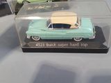 two toy cars that are sitting in a display case