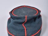 navy blue hat with red pips on the side of the hat