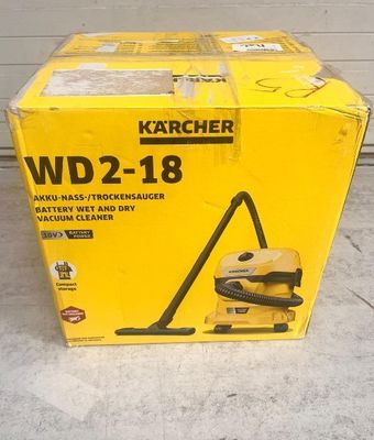 the box of a vacuum cleaner is sitting on the floor