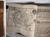 two pictures of a book with a map on it and a book with a picture of a map on it