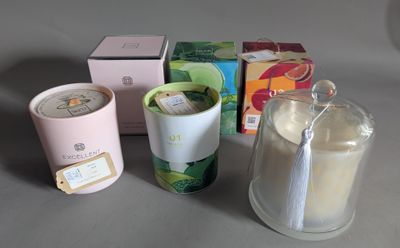 a cup of tea next to a candle and a box of tea bags