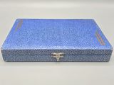 a close up of a blue box on a white surface