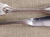 two forks and spoons sitting on a table