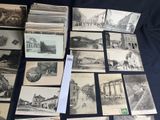 several old black and white photographs of buildings and buildings on a table