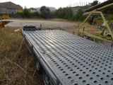 a flatbed truck that is parked in the grass