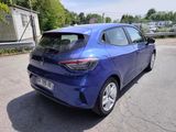 the rear end of a blue car parked in a parking lot