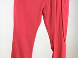 a pair of red pants hanging on a clothes rack