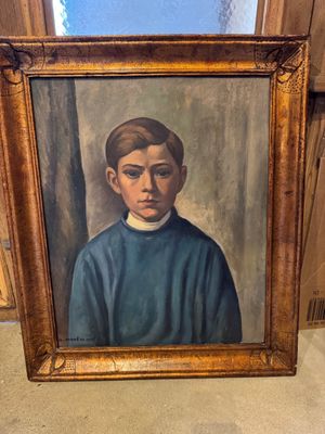 portrait d'un jeune garçon vêtu d'un pull bleu, dans un cadre doré