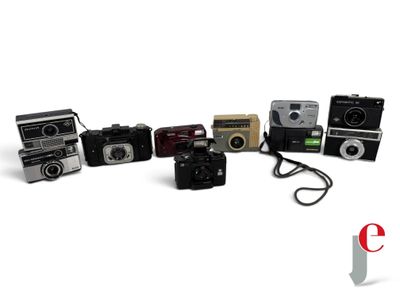 a lot of cameras that are lined up on a table