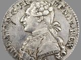 gros plan d'une pièce d'argent sur laquelle figure une femme