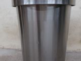 a metal pot that is sitting on the ground