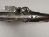 a close up of a gun on a white surface