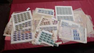 a lot of stamps on a table with a red table cloth