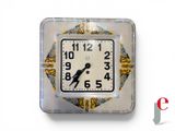 a clock that is sitting on the wall in front of a white background