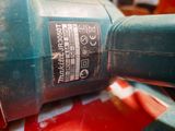a close up of a drill on a red surface