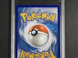 a close up of a pokemon card on a black surface
