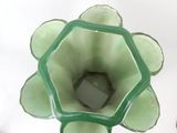a green vase that is sitting on a table