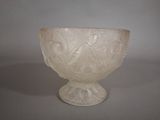 a white glass bowl sitting on top of a table