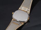 a close up of a wrist watch on a black surface