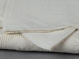 the white fabric is folded on top of the white cloth