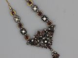 an image of a necklace with pearls and garnets on it