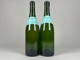 two bottles of wine sitting next to each other on a table