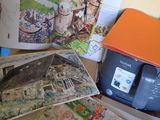 a pile of books and a printer on a table