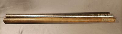 an image of a couple of metal pipes sitting on top of a white sheet