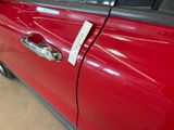 a red car with a sticker on the side of it