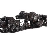 a statue of a herd of elephants on a white background