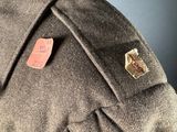 the back of a brown jacket with a badge on it