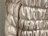a white purse with a large ruffled design on it