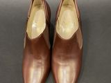 a pair of brown shoes on a black surface