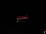 a bench that is sitting in the dark by the water