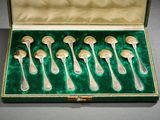 six silver spoons in a green velvet case