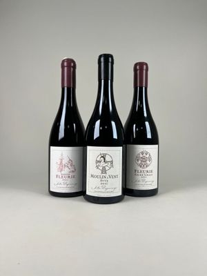 trois bouteilles de vin rouge sont alignées sur une table