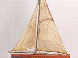 a small wooden sailboat with a sail on it